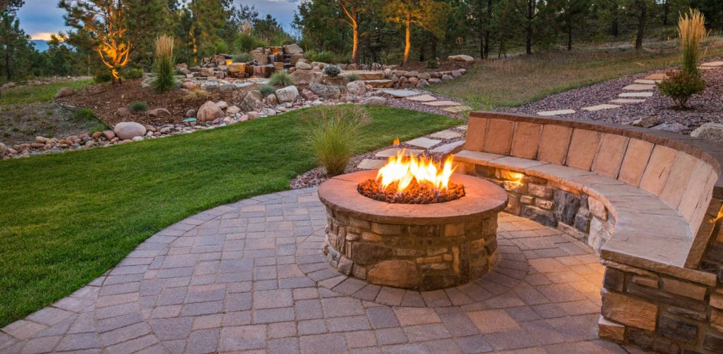 A fire pit and beautiful landscaping installed by Scott's Lawn Care.