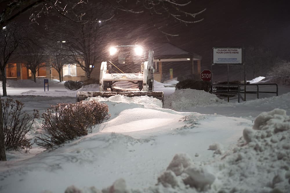 Scotts Lawn Care snow clearing service helping clear a commercial business's parking lot.