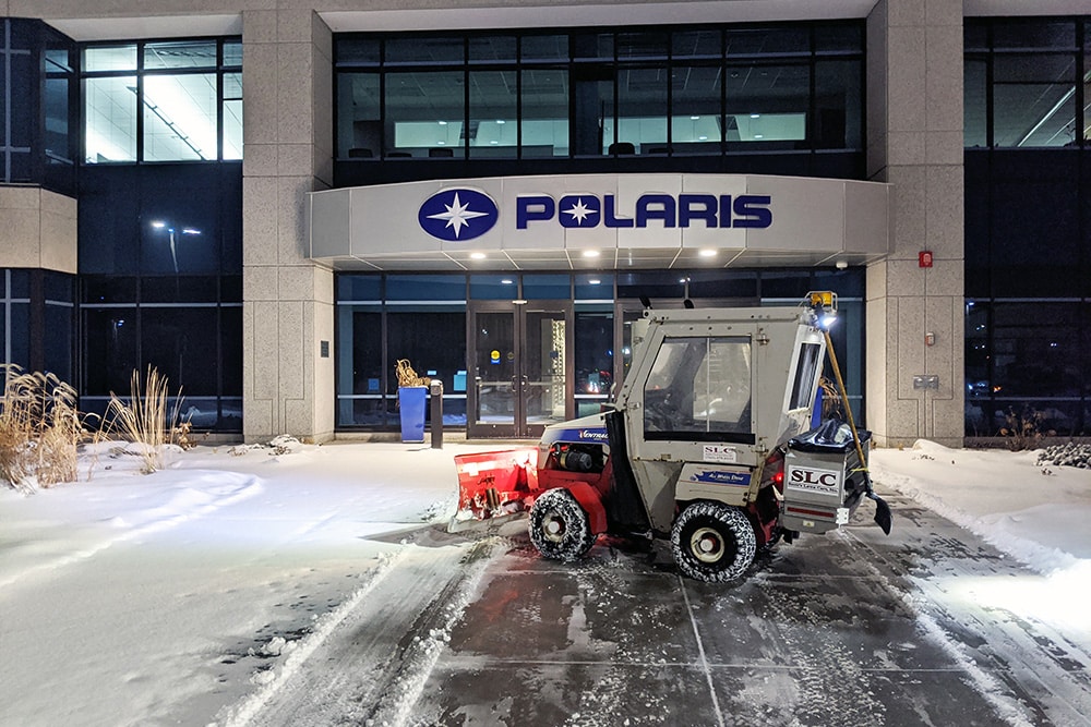 A Scott's Lawn Care snow removal bulldozer in front of Polaris headquarters in Medina, MN