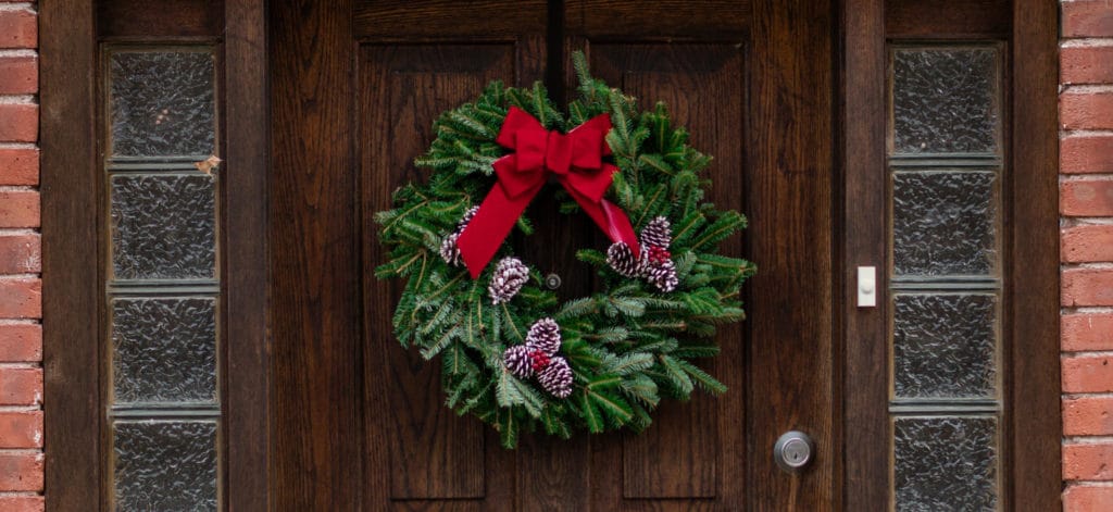 A Christmas wreath hung on a wooden door