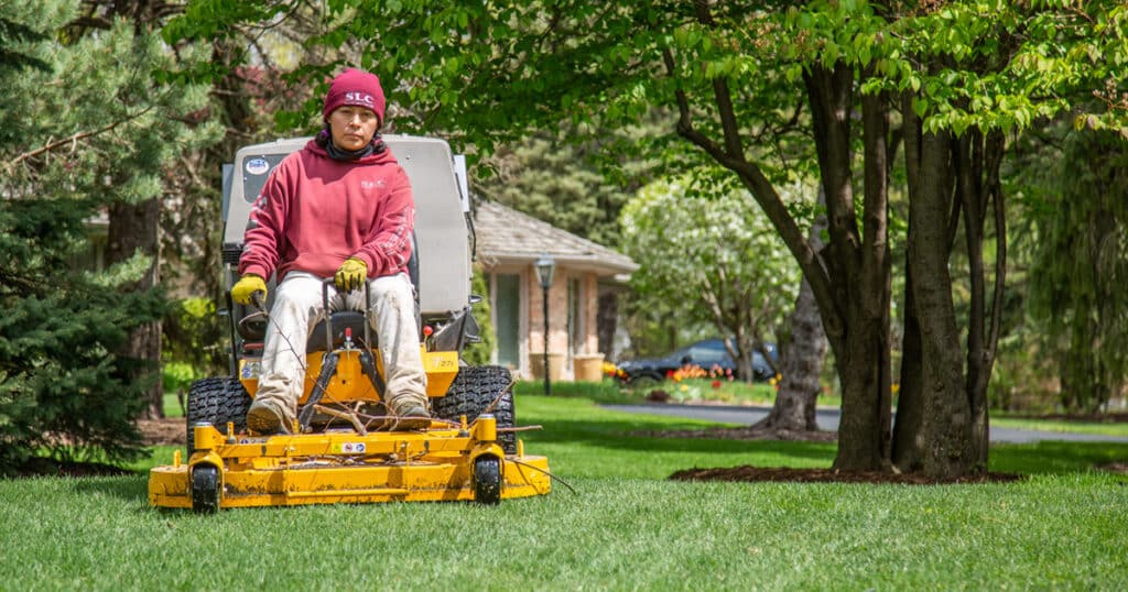 Scott's Lawn Care professional mowing a lawn