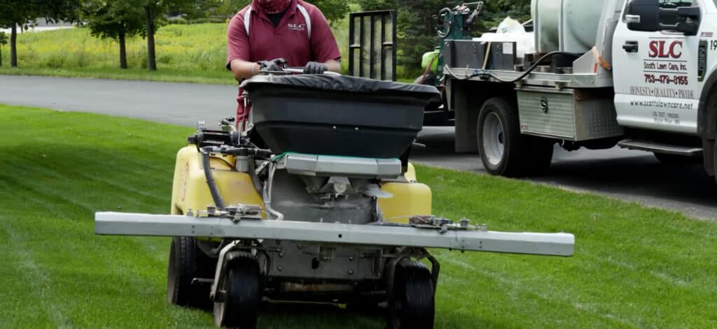 A Scott's Lawn Care professional drives a machine of herbicides